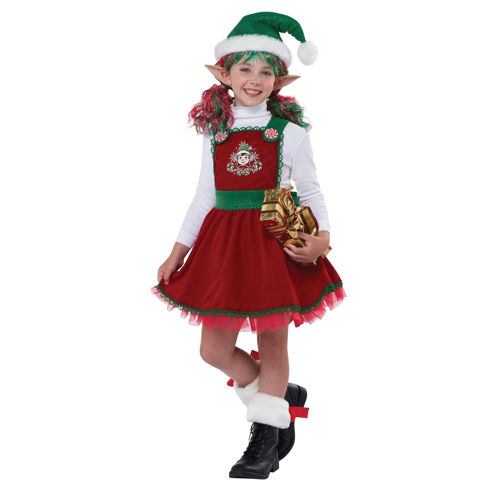 An adorable child dressed as an elf holding a candy cane