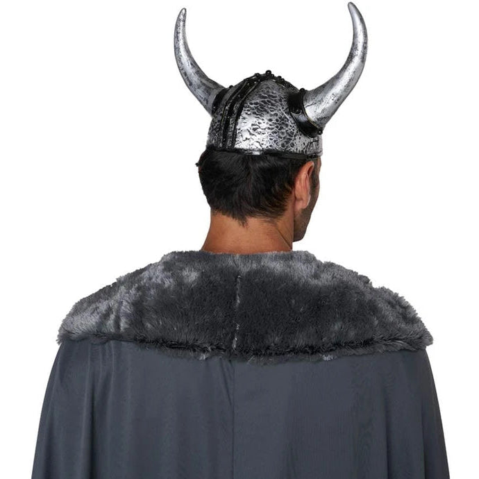 A man viewed from behind wearing a Viking-style costume with a horned helmet and a dark gray cape with faux fur trim, against a plain white background.