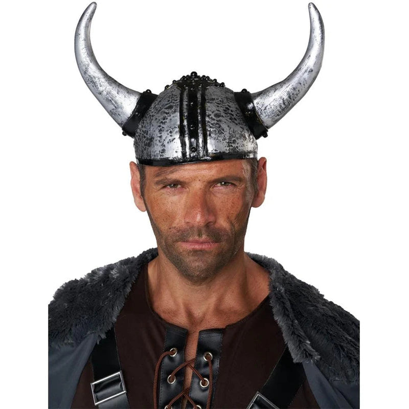 A man wearing a Viking-style horned helmet with a metallic silver finish and black accents, paired with a dark brown tunic and gray fur-trimmed cloak, against a plain white background.