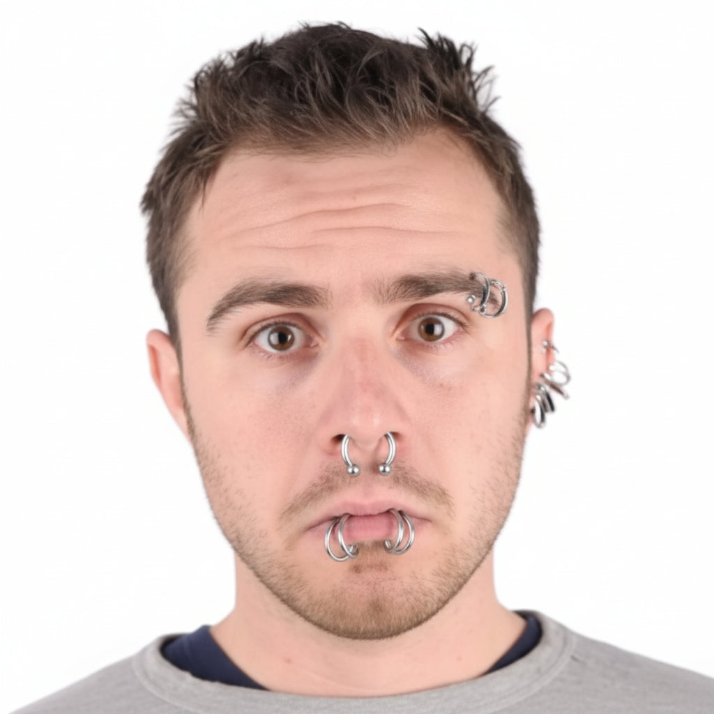 A man wearing multiple body piercings, shown beside the retail packaging of a 'dress me up' body piercing set. The package contains six silver-toned piercing rings on a black backing card.