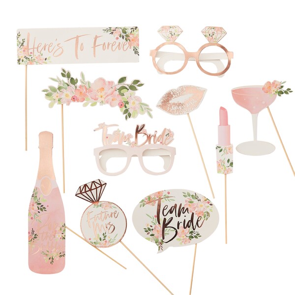 Two women posing with Ginger Ray Rose Gold Floral Hens Party Photo Booth Props, adding a touch of glamour to their party