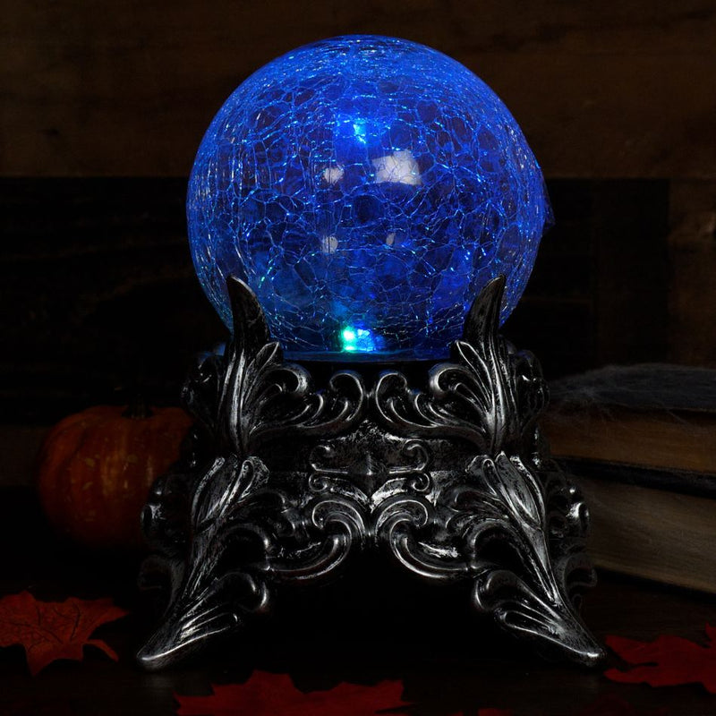 Shiny crystal ball with intricate designs and mystical symbols floating inside