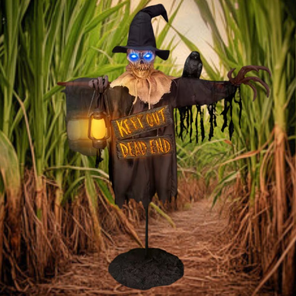 78-Inch Animated Scarecrow with Lantern and Sign in a Pumpkin Patch at Night