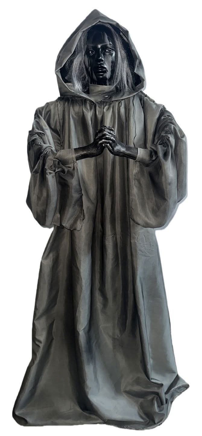 Halloween ghostly figurine on a plain white background: dark hooded robe with a pale face and outstretched hands, and