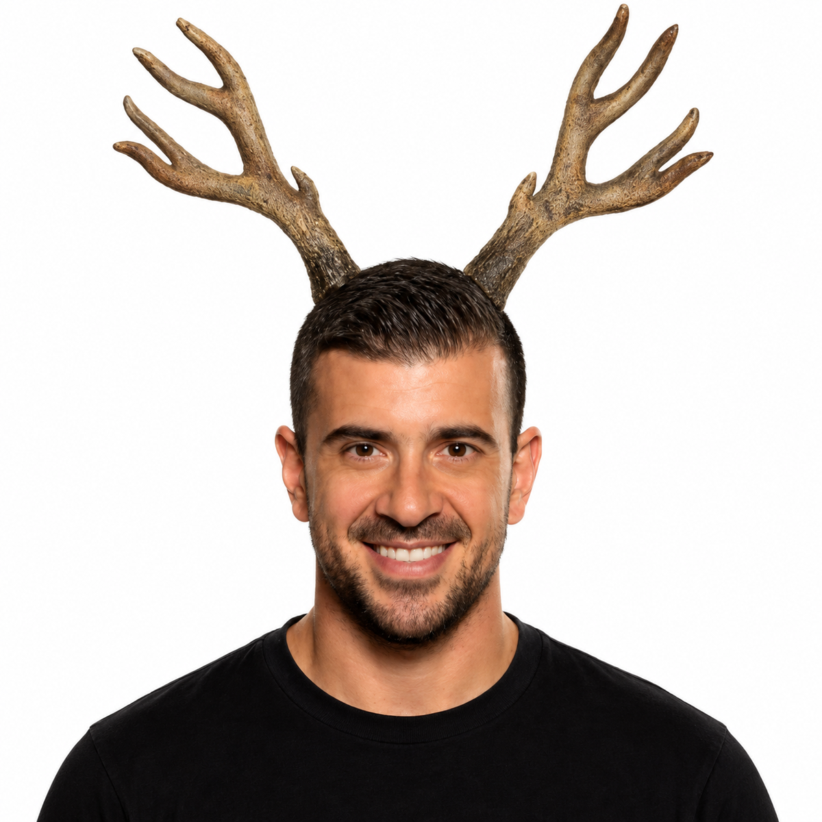 A smiling man with short dark hair and a beard wearing a realistic brown antler headpiece, photographed against a plain white background.