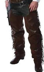 Man wearing the Cowboy Chaps Men's Costume showing the complete front view of the dark brown faux suede fringed vest and full-length fringed chaps with a grey cowboy hat black boots and a toy gun holster on a white background