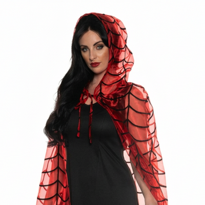 A woman modeling a black maxi dress with a sheer red and black spiderweb-patterned hooded cape on a white studio background.