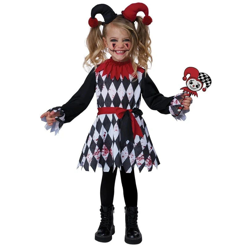 A young girl modeling a scary clown costume against a plain white background. The costume features a black and white harlequin pattern dress with a red collar, red waist sash, and red-and-black jester hat with a small matching plush toy.