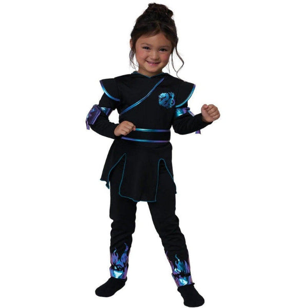 A young girl modeling a black ninja costume with blue and purple flame accents, set against a plain white background.