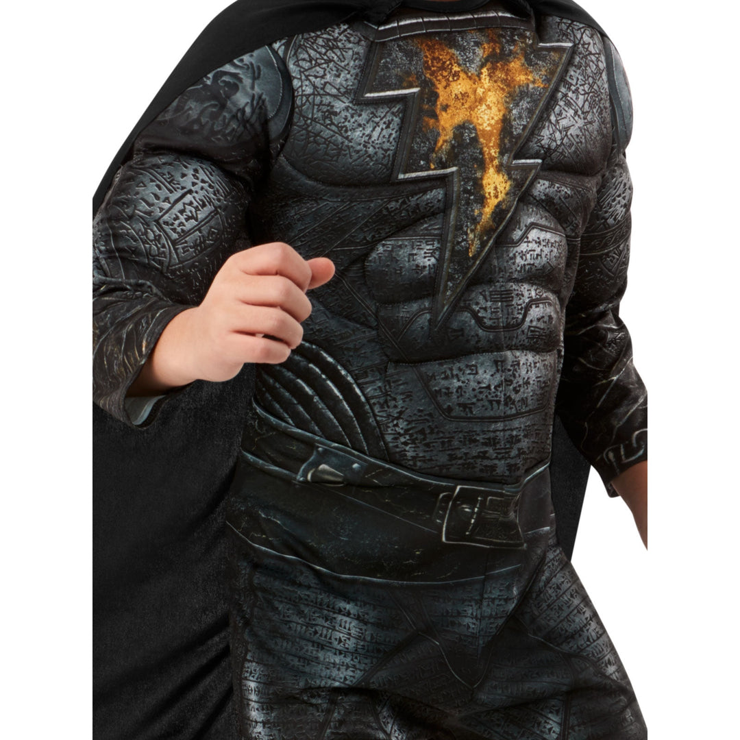 A young child wearing a realistic and high-quality Black Adam costume