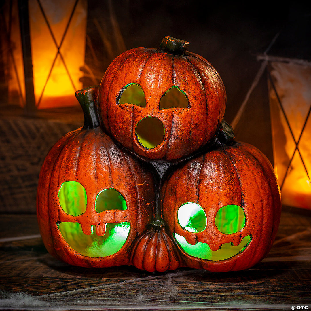 Three smiling jack-o'-lanterns with glowing LED lights for Halloween decor