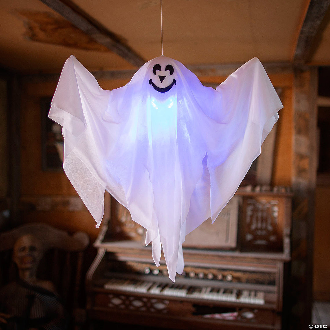 Hanging light-up smiling ghost decoration glowing in the dark