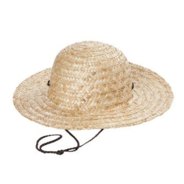 Adorable young girl playing in the park with a stylish straw hat on a summer afternoon