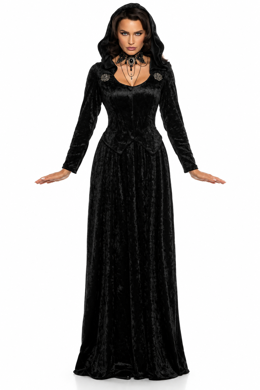 A woman modeling a long black velvet gothic gown with long sleeves, a scoop neckline, and decorative shoulder embellishments, set against a plain white background.