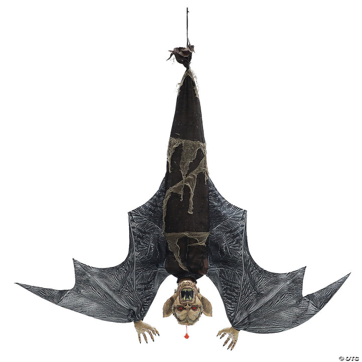 A menacing black bat with outstretched wings hanging from a branch