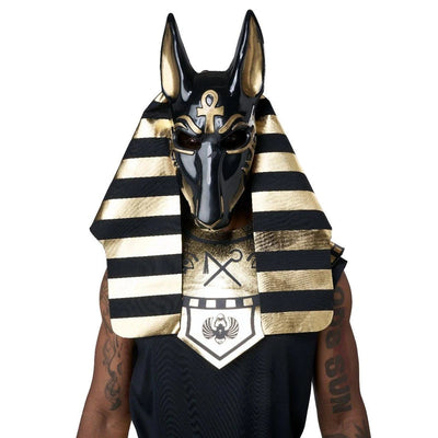 A person wearing an Egyptian Anubis mask costume with a black and gold striped headdress and a matching black chest piece, shown against a plain white background.