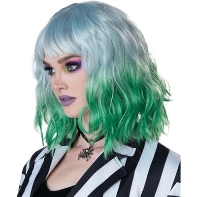 A short wavy wig with a silver-gray top and green-to-blue ombre ends, styled on a model wearing a black and white striped jacket against a white background.