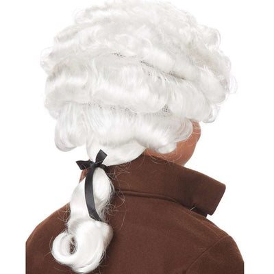 Young boy dressed in historical clothing and wearing white colonial wig
