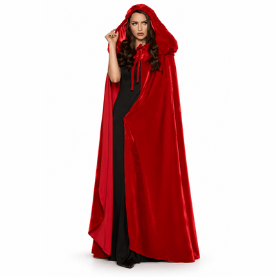 A woman modeling a long red hooded cape over a black dress against a plain white studio background.