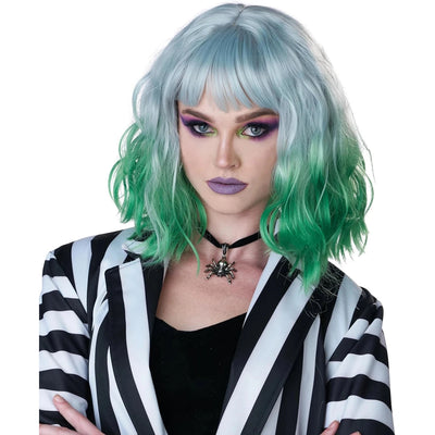 A model wearing a short, wavy wig with a silver-gray top that fades into bright green at the ends, styled with a straight fringe. The model is also wearing a black and white striped blazer, a black top, and a black spider choker against a plain white background.