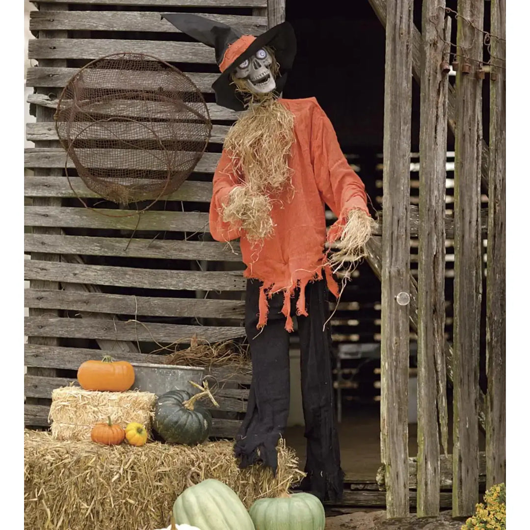 Spooky Halloween decoration with scarecrow holding pumpkin and moving head
