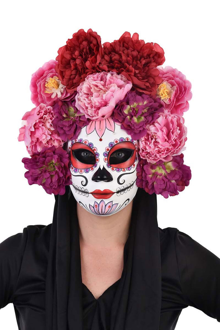 Handmade pink floral Day of the Dead mask with intricate details and vibrant colors