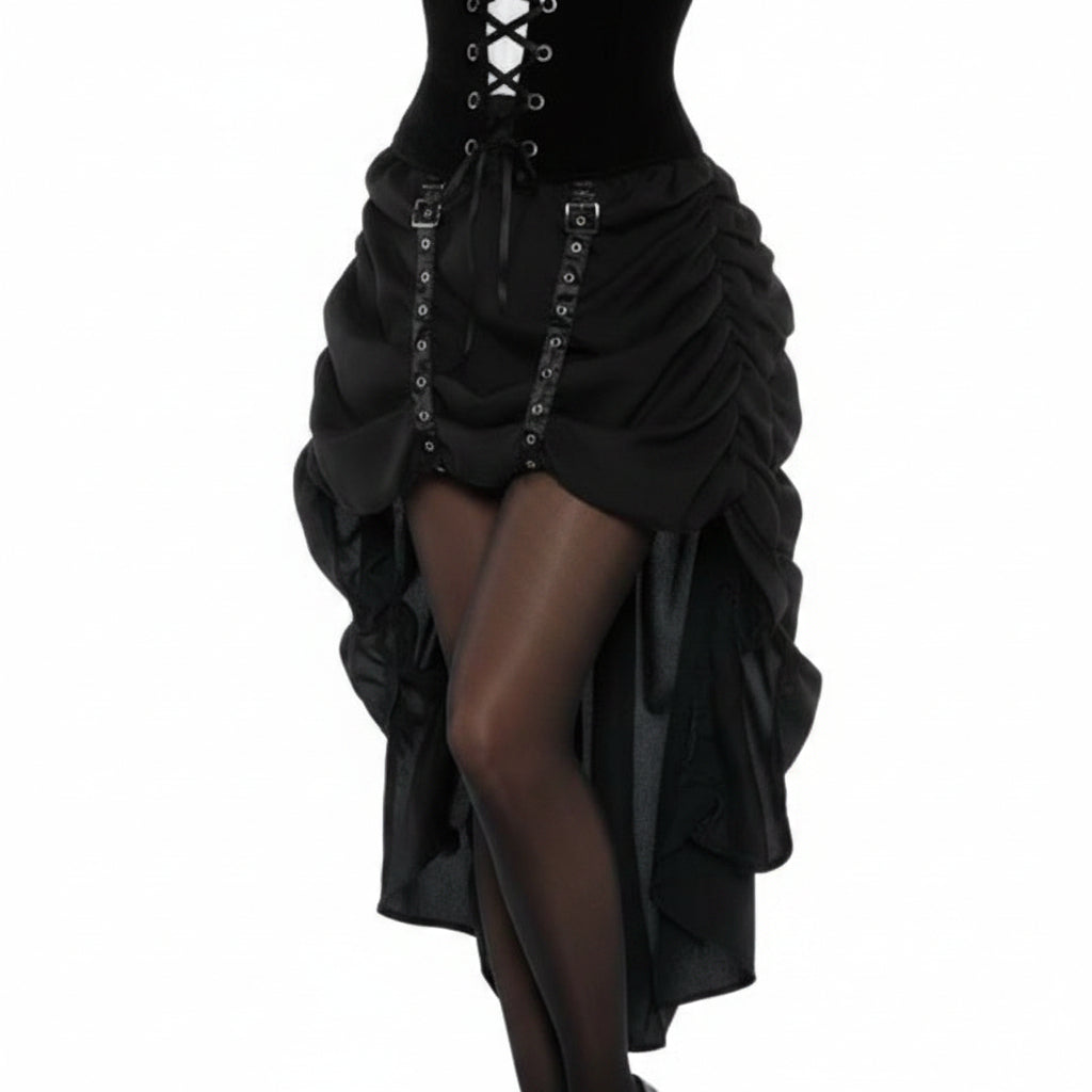 A woman modeling a steampunk costume consisting of a black corset-style dress with white ruffled sleeves, a black top hat with goggles, sheer black tights, and black high-heeled boots, against a plain white background.