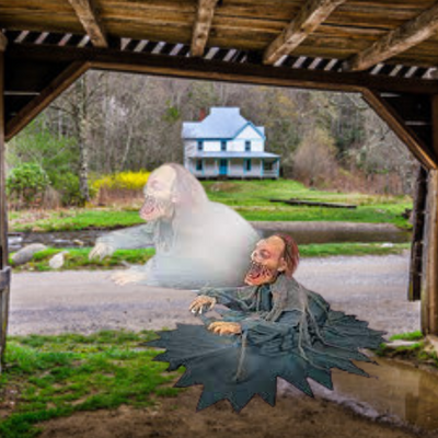 Spooky Halloween prop of a lunging zombie reaper in tattered clothing