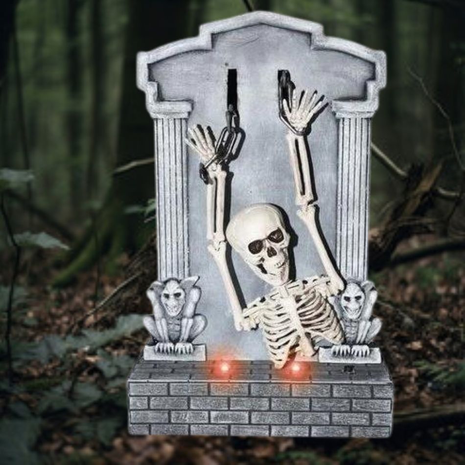 Creepy shaking skeleton with glowing eyes on tombstone for Halloween decor