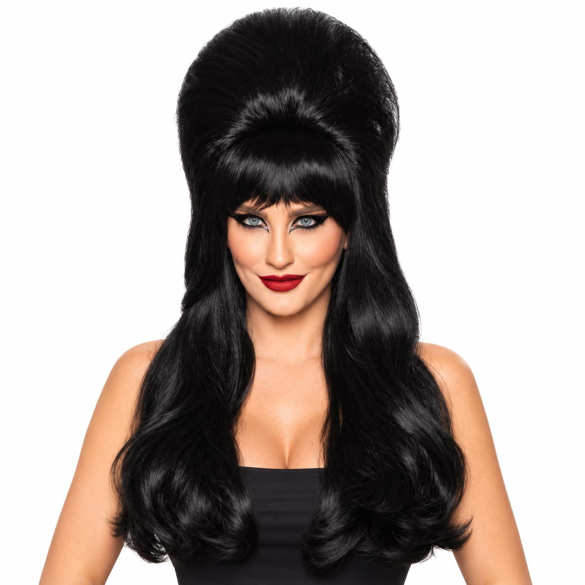 A woman modeling a long, black, voluminous wig with a high bouffant top and loose waves, styled like a classic 1960s or 1970s glamour hairstyle, on a solid white background.