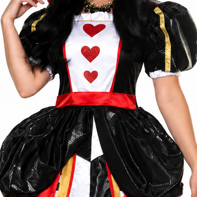 A woman modeling a Queen of Hearts costume against a plain white background. The costume includes a black and red dress with a white chest panel, red hearts, a black-and-white checkered front panel, gold trim, a black-and-white striped collar, and a gold crown.
