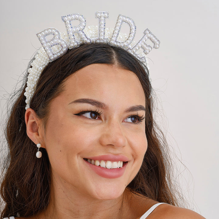 Bride wearing a pearl embellished headband with intricate floral design