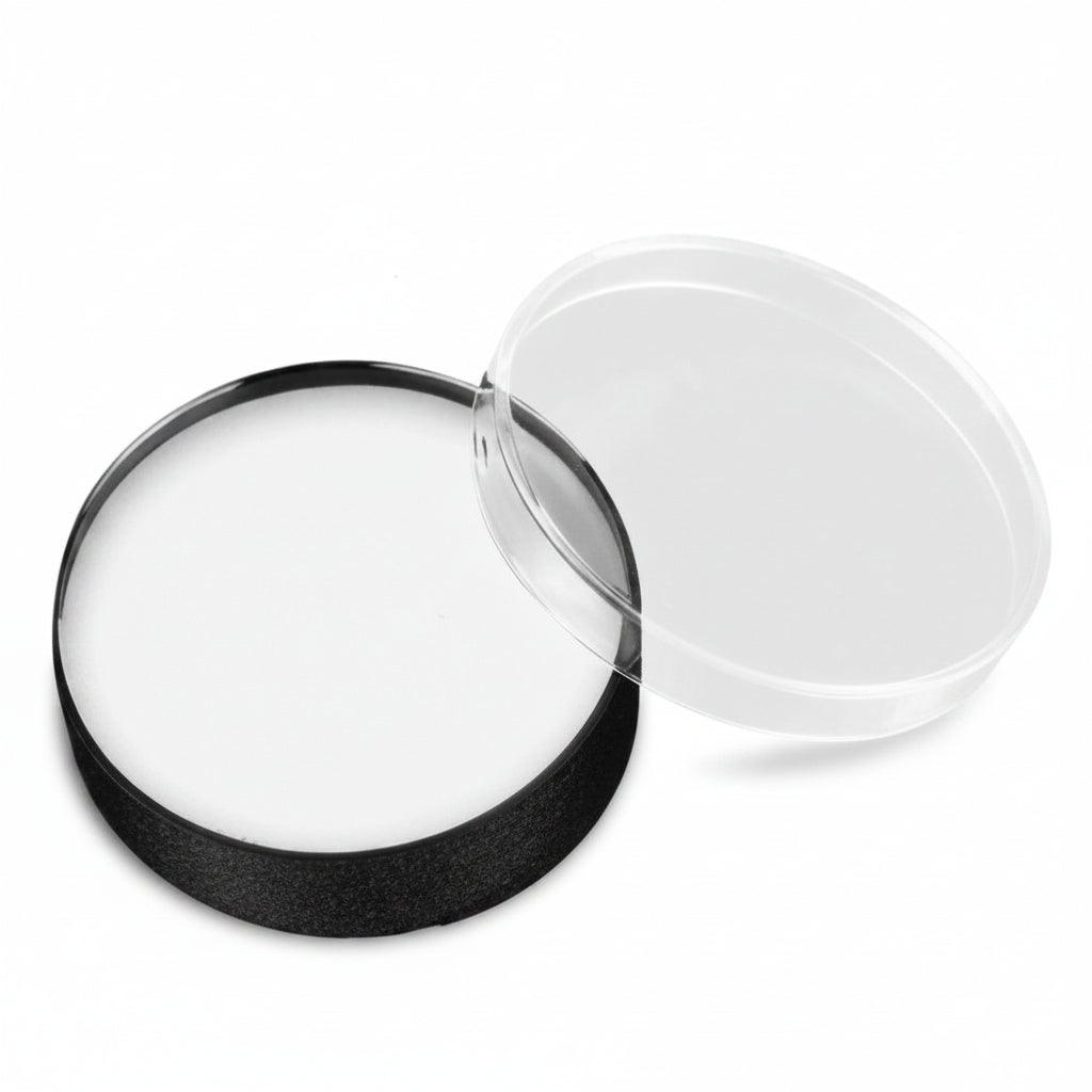 A circular clear lens or cover with a black rim, shown open on a plain white background.