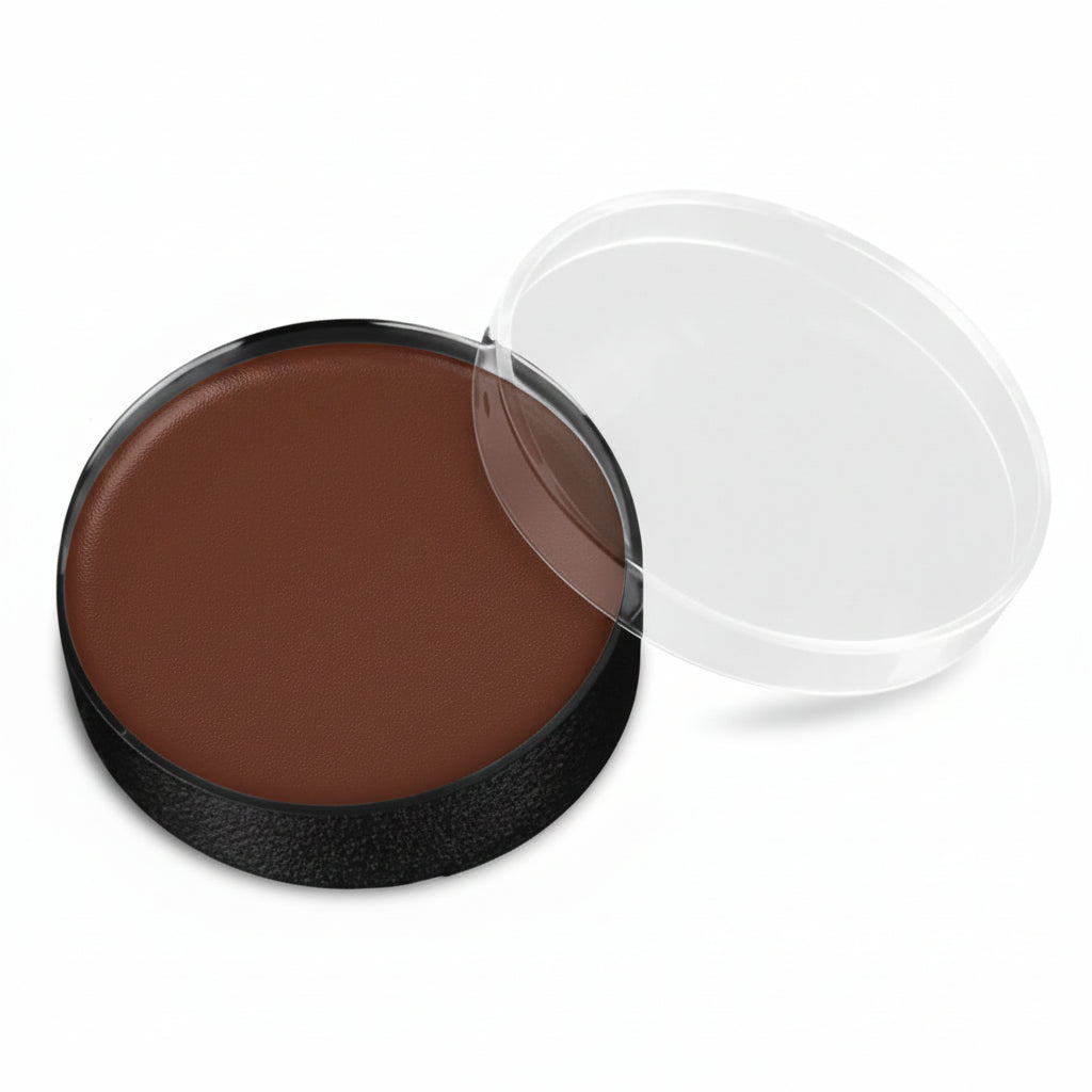 A round makeup compact with a dark brown pressed powder or cream product, shown open with a clear plastic lid resting beside it on a white background.