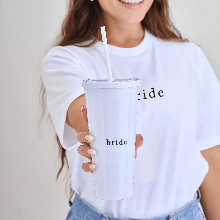 White reusable cup with lid and straw, decorated with 'Bride' in gold script