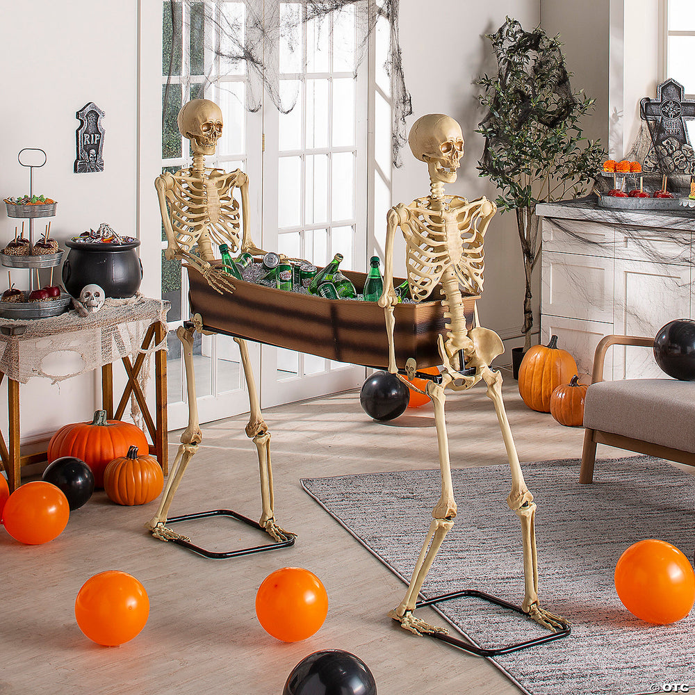  Halloween decoration of two skeletons carrying a black coffin in a spooky setting