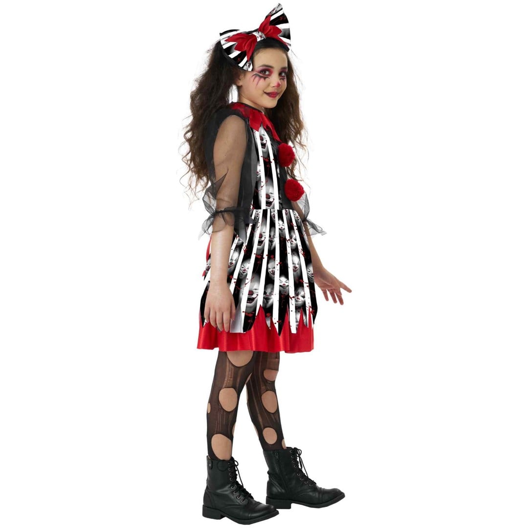 A child modeling a Halloween costume consisting of a black and white striped dress with red trim, sheer black mesh sleeves, black polka-dot tights, black combat boots, and a matching black, white, and red bow headband, set against a plain white background.